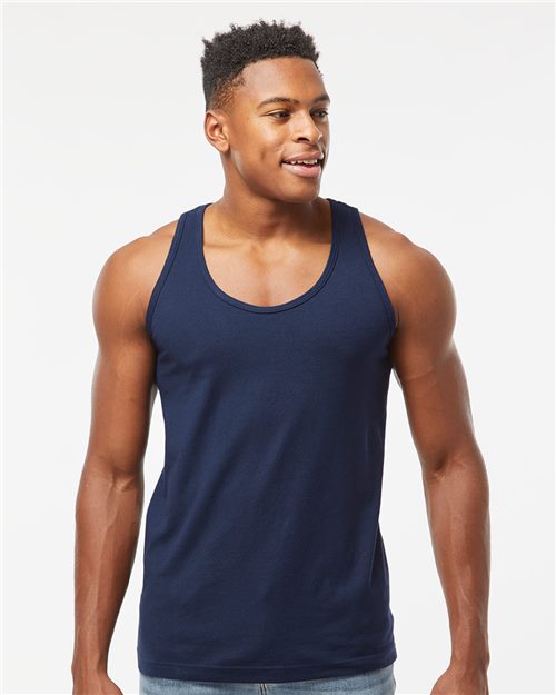 Load image into Gallery viewer, A smiling man in a Tultex Fine Jersey navy blue tank top, made from USA cotton and paired with blue jeans, stands against a white background, highlighting the comfort and quality of sustainable manufacturing.