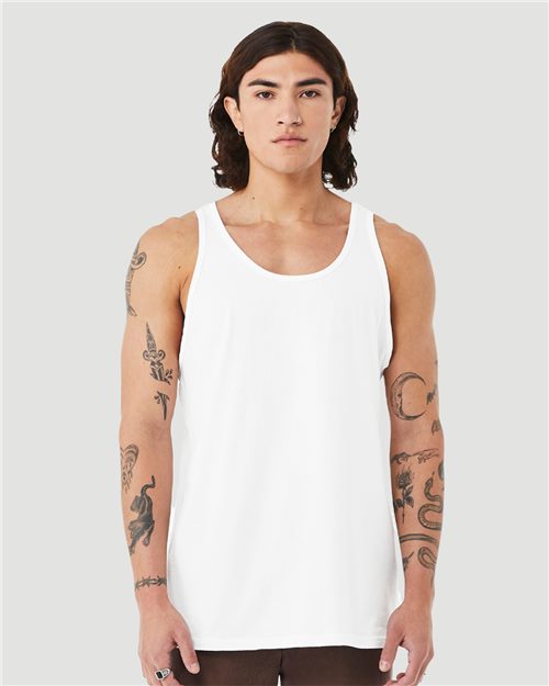 Load image into Gallery viewer, A person with long hair and tattooed arms wears a BELLA + CANVAS - Heather CVC Tank, made from Airlume combed cotton. They stand against a light gray background, looking directly at the camera, embodying style and eco-friendly sophistication.
