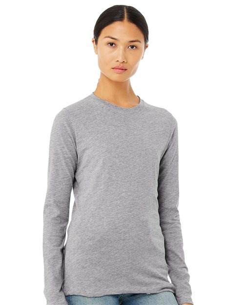 Load image into Gallery viewer, A person with long dark hair tied back is wearing a BELLA + CANVAS Women's Jersey Long Sleeve Tee in gray and semi-relaxed fit light blue jeans. They stand against a plain white background, exuding effortless style and comfort.