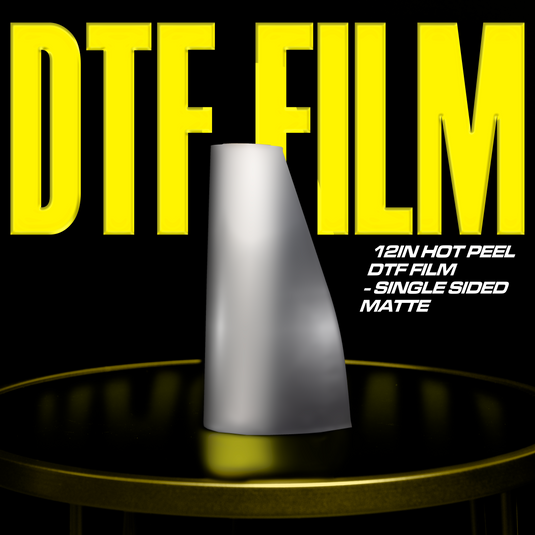 A roll of DTF film stands upright on a table. In the background, large yellow text reads