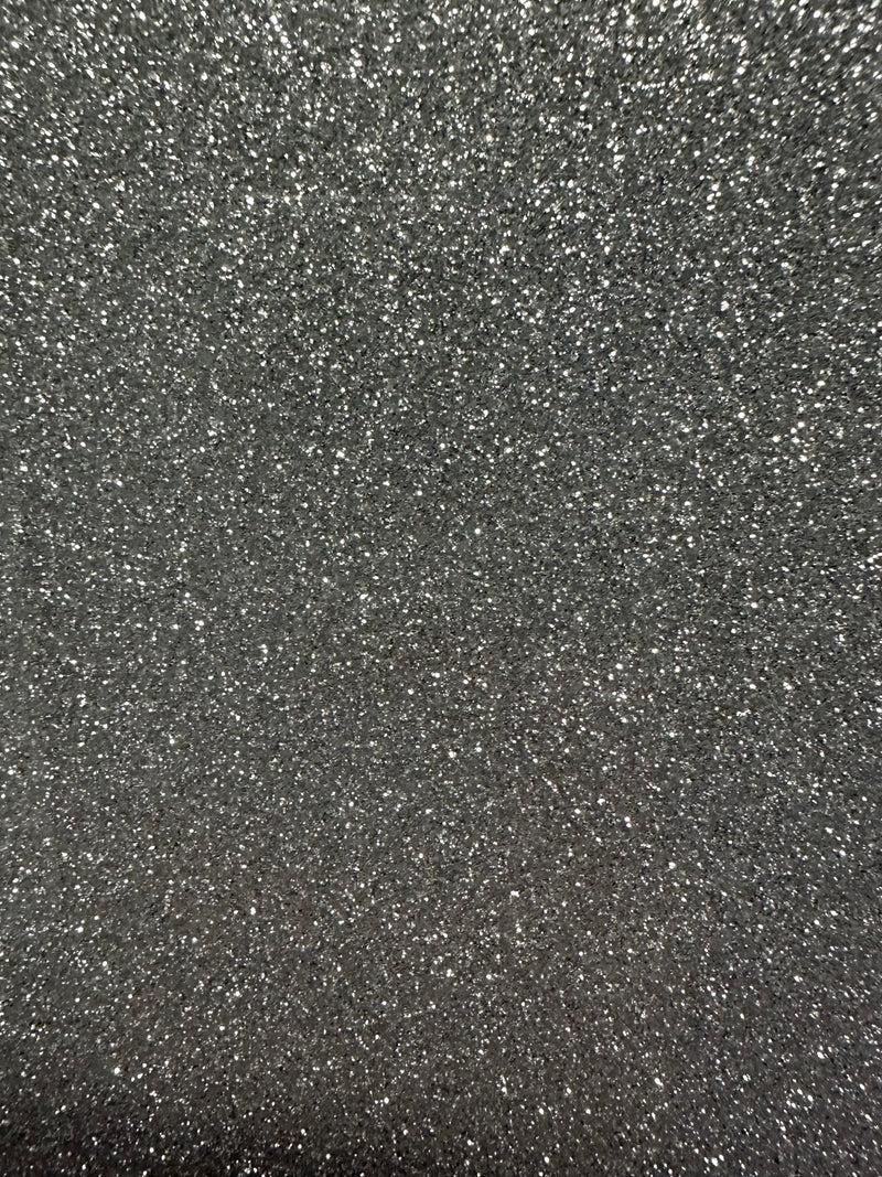 Load image into Gallery viewer, The Quick Transfers EconoGlitter Vinyl 19.8" x 12" sparkles against a dark background, creating a textured and shimmering effect.