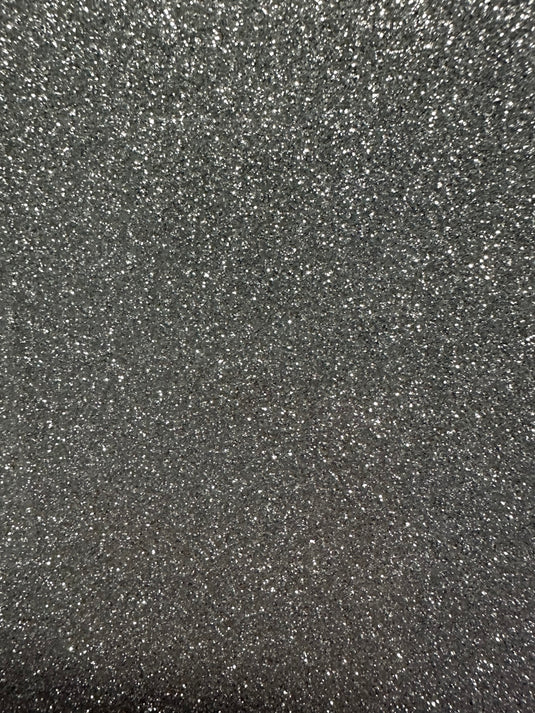 The Quick Transfers EconoGlitter Vinyl 19.8" x 12" sparkles against a dark background, creating a textured and shimmering effect.