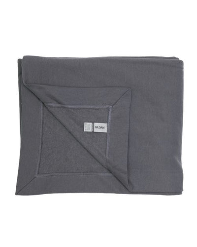 A neatly folded dark gray Gildan Heavy Blend Fleece Stadium Blanket features a brand tag on one corner. Made from a heavy blend, it offers a soft and smooth feel, ensuring cozy comfort and peace of mind with OEKO-TEX certification.