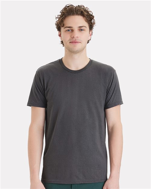 A man with short curly hair wearing a Hanes - Perfect-T DTG T-Shirt in dark gray cotton stands against a light gray background.