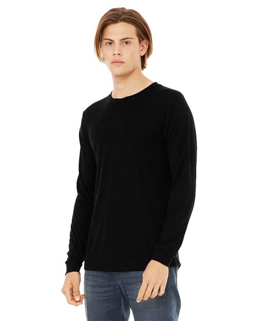 Load image into Gallery viewer, A person with shoulder-length hair wears a BELLA + CANVAS Jersey Long Sleeve Tee in black and blue jeans, standing against a white background.
