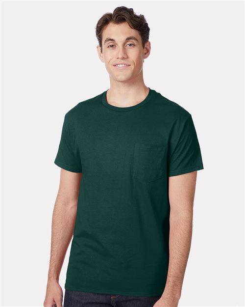 Load image into Gallery viewer, A person is smiling in a Hanes - Authentic Pocket T-Shirt. This dark green, comfortable cotton jersey shirt stands out against the plain white background, showcasing its sustainable manufacturing roots.
