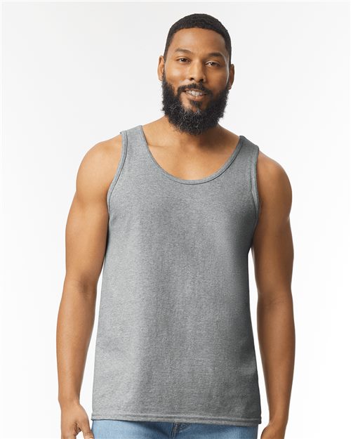 Load image into Gallery viewer, A bearded man with short hair wears a gray Gildan Ultra Cotton® Tank Top and blue jeans, standing against a plain white background with a relaxed expression, facing forward.
