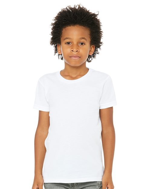 A young child with curly hair is wearing the BELLA + CANVAS Youth Jersey Tee, made from soft Airlume combed cotton, and gray pants against a white background, showcasing the comfort and style of unisex sizing.