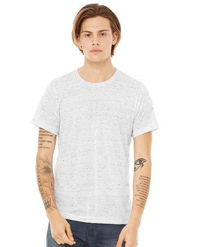 Facing forward against a plain white background, a person with shoulder-length hair wears the unisex BELLA + CANVAS - Texture Tee in a light speckle design, made from Airlume combed and ring-spun cotton. Their tattooed arms rest at their sides, highlighting its sustainable manufacturing.