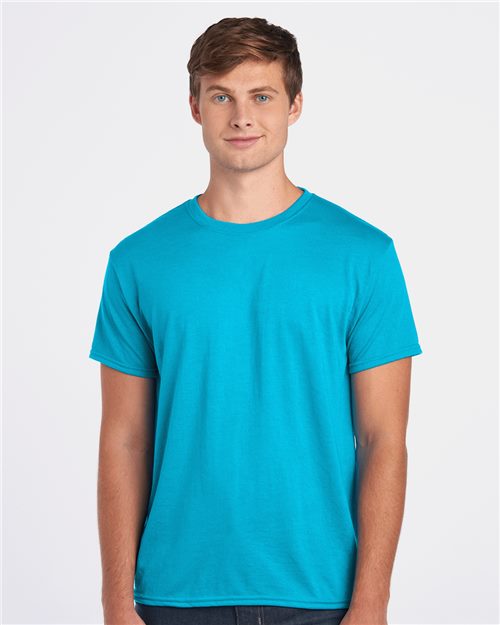 A person with short brown hair wears a bright blue JERZEES - Dri-Power® Performance T-Shirt, blending cotton comfort with polyester durability for moisture management. They stand against a plain white background, facing forward neutrally.