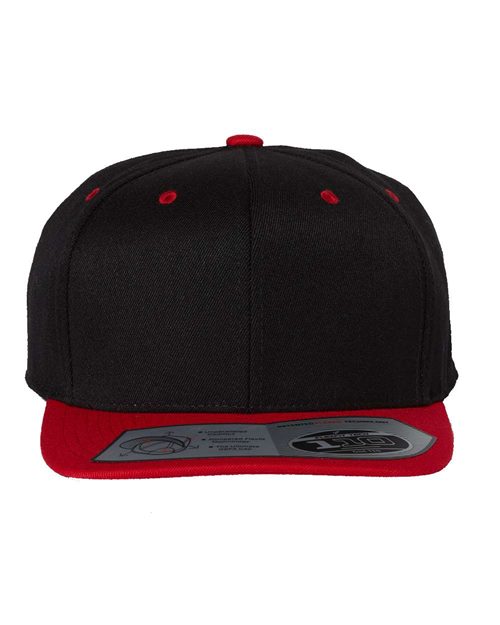 The Flexfit - 110® Snapback Cap by Flexfit is a black structured hat with a flat red brim, red embroidered eyelets, adjustable snapback closure, and branding sticker. It includes a moisture-management sweatband for all-day comfort.