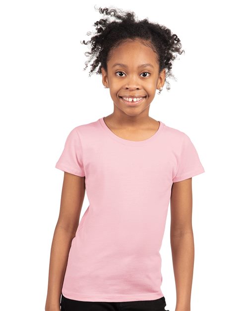 Load image into Gallery viewer, A cheerful curly-haired child beams in a pink Next Level - Girls’ Cotton Princess T-Shirt, crafted from combed ring-spun cotton. The plain white background showcases the quality and comfort of its socially conscious manufacturing.
