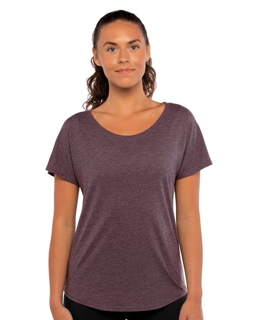 Load image into Gallery viewer, With long brown hair and a confident gaze, a person models Next Level&#39;s Women&#39;s Triblend Dolman T-Shirt in maroon, crafted from combed ring-spun cotton, paired with black pants for a sustainable look against a white backdrop.
