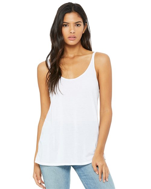 Load image into Gallery viewer, A person with long dark hair is wearing the BELLA + CANVAS Women&#39;s Slouchy Tank, a white top with a relaxed drapey fit, and light blue jeans. They stand against a plain white background, looking directly at the camera with a neutral expression.
