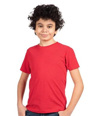 A young person with curly hair is smiling in a plain setting, wearing the Next Level - Youth CVC T-Shirt by Next Level, exemplifying Sustainable Style.