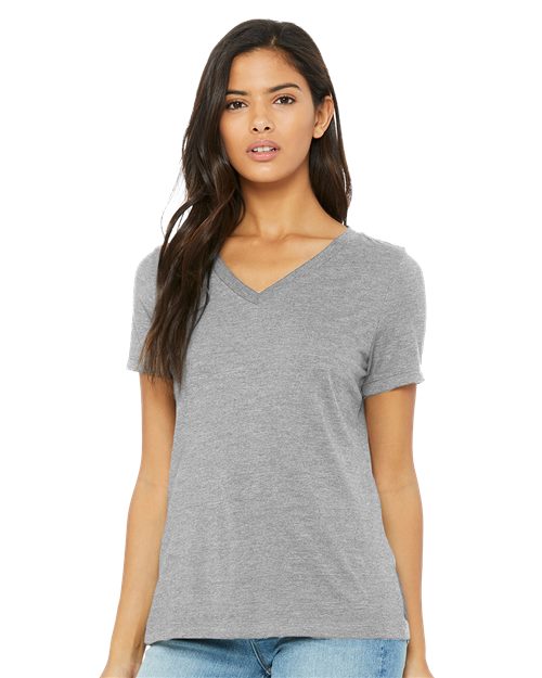 Load image into Gallery viewer, A woman in a BELLA + CANVAS - Women&#39;s Relaxed Heather CVC V-Neck Tee and blue jeans is standing and looking forward.
