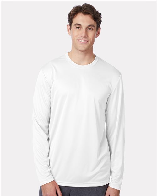 Load image into Gallery viewer, A person with short brown hair wears a Hanes - Cool DRI® Long Sleeve Performance T-Shirt in plain white, smiling against a light gray background, showcasing its excellent moisture-management properties.
