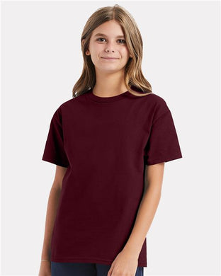 A young person with long hair stands against a white background, gently smiling while wearing a plain maroon Hanes - Authentic Youth T-Shirt made of 100% cotton jersey.