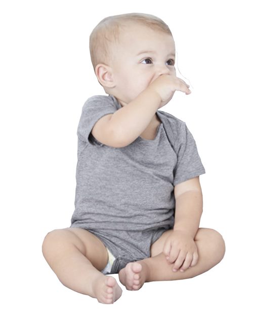 An infant in a gray BELLA + CANVAS Triblend Short Sleeve One Piece, made from Blue Sign certified dyes, sits on the floor. With light hair, they touch their nose and gaze upward against a white background.