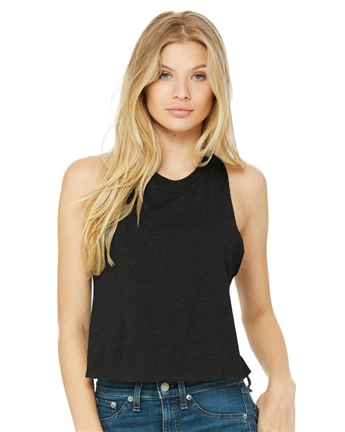 Load image into Gallery viewer, The long-haired person in blonde is wearing a black BELLA + CANVAS Women&#39;s Racerback Crop Tank made from Airlume cotton, paired with blue jeans, against a plain white background, highlighting stylish and sustainable fashion.
