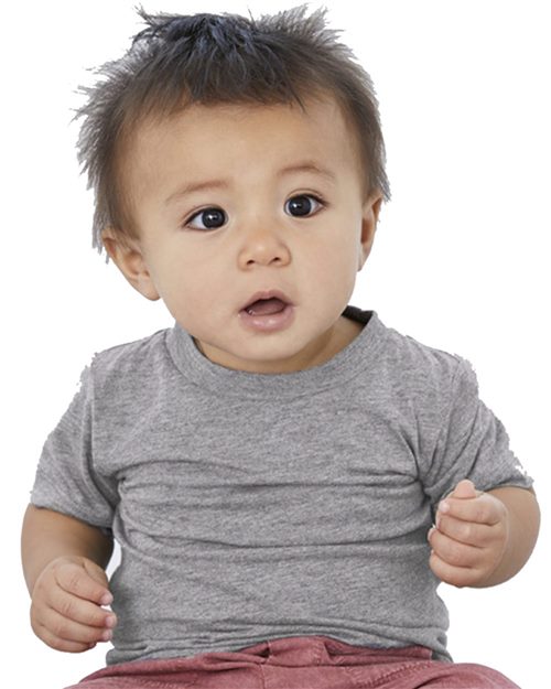 A baby with tousled hair, wearing the gray BELLA + CANVAS Infant Triblend Tee and pink pants, sits against a plain white background with a surprised look. This unisex tee ensures comfort and style for all little ones.