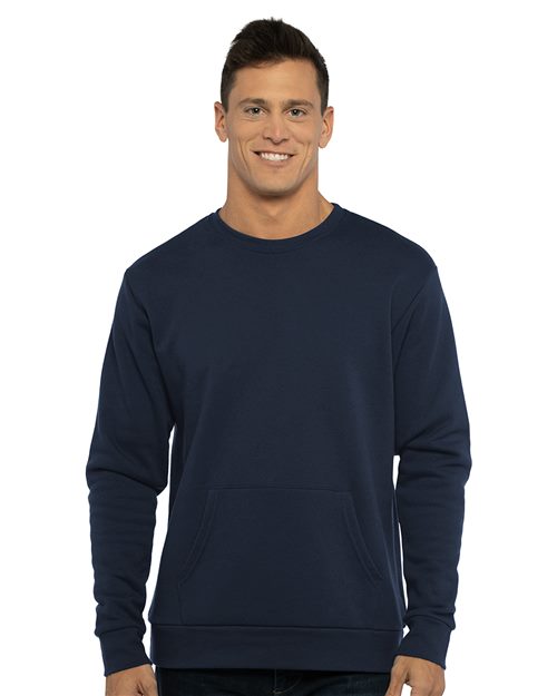 Load image into Gallery viewer, A man smiles against a plain white background, wearing the Next Level - Santa Barbara Pocket Crewneck Sweatshirt in dark blue, made from cozy cotton/polyester fleece.
