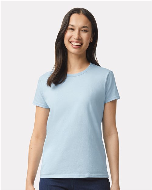 A woman with long dark hair smiles in her light blue Gildan - Ultra Cotton® Women’s T-Shirt. The OEKO-TEX certified top features short sleeves and a classic round neckline, enhancing her look against a plain white background.