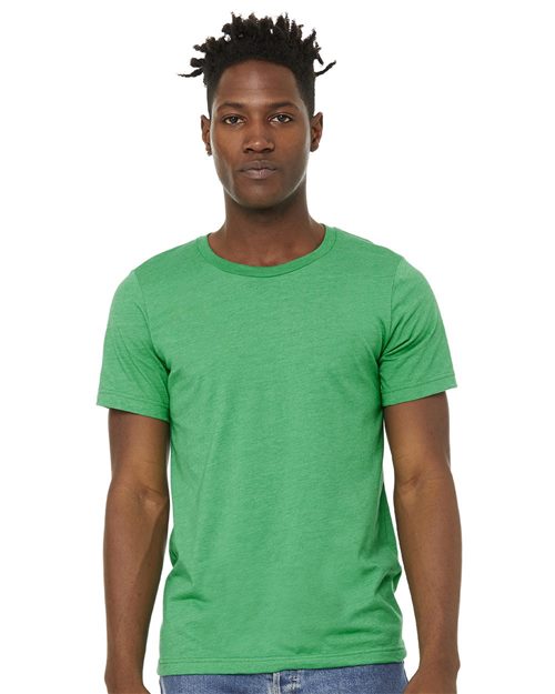 Against a white background, a person wears the BELLA + CANVAS Sueded Tee, crafted from Airlume combed cotton, paired with blue jeans. The unisex sizing guarantees comfort as their arms rest relaxed at their sides.