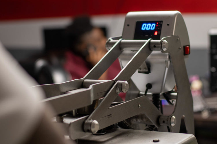 Close-up of a heat press machine with a digital display showing 