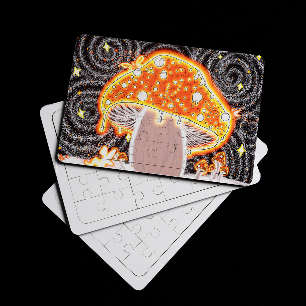 The Blank Sublimation Puzzle (5x7") by Quick Transfers showcases a vibrant orange mushroom with white spots against a starry black background. Partially assembled, it invites your personal touch as a few blank pieces await beneath it.