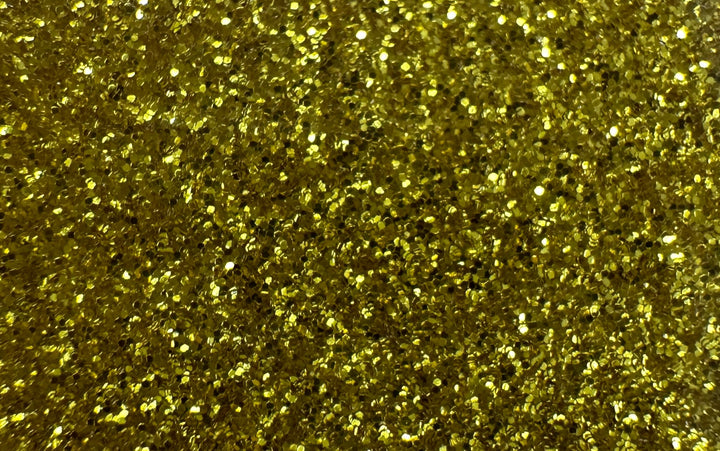 The image features a vibrant golden glitter texture with sparkling particles. Quick Transfers' EconoGlitter Vinyl 19.8" x 12" ensures this mesmerizing effect is durable and perfect for any project needing enduring brilliance.