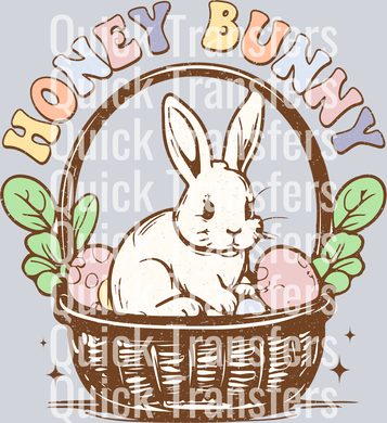 The Adorable Honey Bunny Easter Basket Eggs DTF Transfer by Quick Transfers features a cute white bunny in a basket with Easter eggs and leaves, plus 