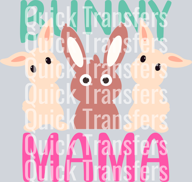 The Cute Bunny Mama Easter Pastel Trio Graphic Heat Transfer from Quick Transfers features two cream and one brown cartoon bunnies before “Bunny Mama” in green and pink on a light background. Ideal for Easter designs. Watermarked with “Quick Transfers.”.