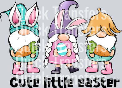 The Adorable Easter Gnome Trio With Egg Ready To Press Transfer by Quick Transfers features pastel gnomes in bunny hats, holding carrots and an egg. Perfect for your next project; text reads 