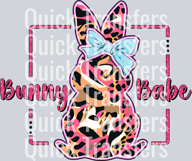 The Vibrant Bunny Babe Leopard Print Bow Glitter Transfer by Quick Transfers features a bunny silhouette in pink, orange, and black leopard print with a light blue bow and 