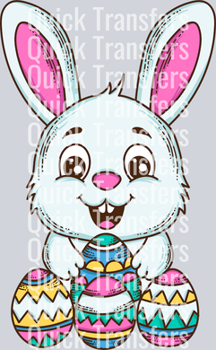 Adorable Easter Bunny With Colorful Eggs DTF Transfer by Quick Transfers features a cute white bunny with big pink ears holding three decorated eggs. Smiling bunny on a light grey background with “Quick Transfers” watermark. Perfect for spring crafts!.