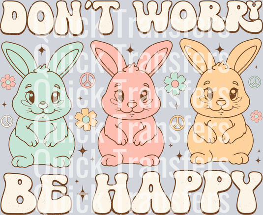 The Premium Dont Worry Be Happy Pastel Bunny Trio Transfer by Quick Transfers features blue, pink, and yellow cartoon bunnies with flowers and peace signs plus bold 
