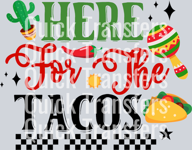 The Vibrant Fiesta Here For The Tacos DTF Heat Transfer by Quick Transfers features bold graphics with “Here for the tacos,” a cactus, chili pepper, maraca, taco, sun, florals, and a checkered border—perfect as a ready-to-press DTF transfer.